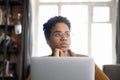 Pensive African employee woman in glasses distracting from work Royalty Free Stock Photo