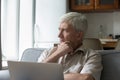 Pensive aged male feel unsure has doubts working on laptop Royalty Free Stock Photo