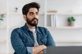 Pensive arab businessman thinking about business plan, working on new project at home office Royalty Free Stock Photo