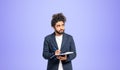 Pensive Arabic college student man portrait with notebook and pen, purple Royalty Free Stock Photo