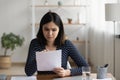 Pensive Asian girl read post paper letter correspondence