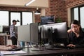 Pensive asian tech enginner working on code development