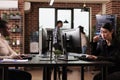 Pensive asian tech programmer working on code development Royalty Free Stock Photo