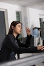 Pensive asian web developer working on html code development Royalty Free Stock Photo