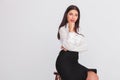 Pensive attractive businesswoman sits on wooden chair