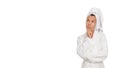 Pensive attractive middle aged woman in robe and towel on head thinking and looking to the side on white isolated background. Royalty Free Stock Photo