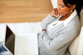 Pensive attractive woman sitting on the floor