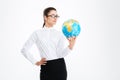 Pensive attractive young business woman holding earth globe Royalty Free Stock Photo