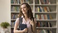 Pensive student girl staring away posing in library Royalty Free Stock Photo