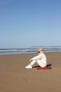 Pensive bald man looking at sea waves