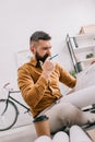 Pensive bearded adult male architect holding blueprint and working on project Royalty Free Stock Photo
