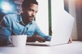 Pensive bearded African man working on laptop while spending time at home.Concept of young business people using mobile Royalty Free Stock Photo