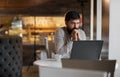 pensive bearded businessman tired of freelancer remote work relaxing in cafe, young man using laptop in coffee house Royalty Free Stock Photo