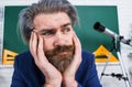 Pensive bearded teacher in classroom. Back to school. Teachers day. Thoughtful professor in class. Royalty Free Stock Photo