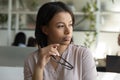 Pensive biracial female worker look in distance thinking Royalty Free Stock Photo