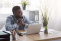 Pensive black businessman dreaming about something while working in office Royalty Free Stock Photo