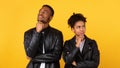 Pensive Black Couple Thinking Standing Back-To-Back Posing Over Yellow Background