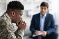 Pensive black soldier having conversation with social worker