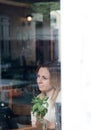 Pensive blonde attractive young adult single woman in pub