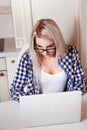 Pensive blonde business woman working on laptop Royalty Free Stock Photo