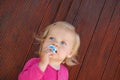 Pensive blue-eyed baby toddler happy with pacifier Royalty Free Stock Photo