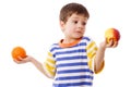 Pensive boy holds a orange and apple Royalty Free Stock Photo