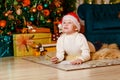 Pensive boy in Santa`s red cap writes a letter to Santa Claus for Christmas . dreams Royalty Free Stock Photo