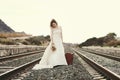 Pensive bride with a red suitcase Royalty Free Stock Photo