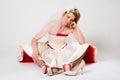 Pensive bride sitting on floor in socks against Royalty Free Stock Photo