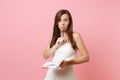 Pensive bride woman in wedding dress holding pencil near lips search ideas for planning wedding, writing notes in