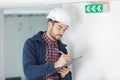 Pensive builder standing with clipboard in hands