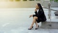 Pensive business lady sitting in downtown, stressful life in big city, career