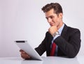 Pensive business man on tablet Royalty Free Stock Photo