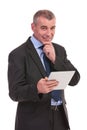 Pensive business man with tablet Royalty Free Stock Photo