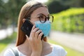 Pensive Business Woman Talking On Smart Phone Using Surgical Mask Avoiding Coronavirus In City Street