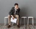 pensive businessman with documents waiting for job interview