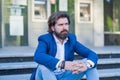 Pensive businessman in formalwear sitting on stairs. Man Relaxing Outside Royalty Free Stock Photo