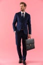 Pensive businessman holding a briefcase and looking away Royalty Free Stock Photo