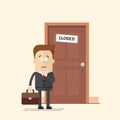 Pensive businessman or manager standing in front of a closed door. A man with a suitcase in a business suit with a tie