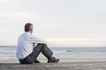 Pensive businessman sitting at the sea