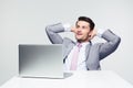 Pensive businessman sitting at the table with laptop Royalty Free Stock Photo