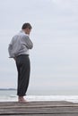 Pensive businessman on the beach