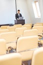 Pensive businessman standing and using laptop in empty meeting hall Royalty Free Stock Photo