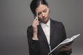 Pensive businesswoman holding pen and diary while planning her work Royalty Free Stock Photo