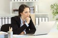 Pensive businesswoman with a laptop at office