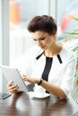 Pensive businesswoman reading an article on tablet computer Royalty Free Stock Photo