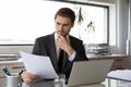 Pensive Caucasian businessman analyze documents in office e Royalty Free Stock Photo