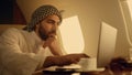 Pensive ceo solving problem on business trip closeup. Focused arab typing laptop Royalty Free Stock Photo