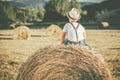 Pensive child in the straw field Royalty Free Stock Photo