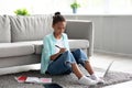 Pensive concentrated teenager afro american girl student study at home with laptop, prepare for test